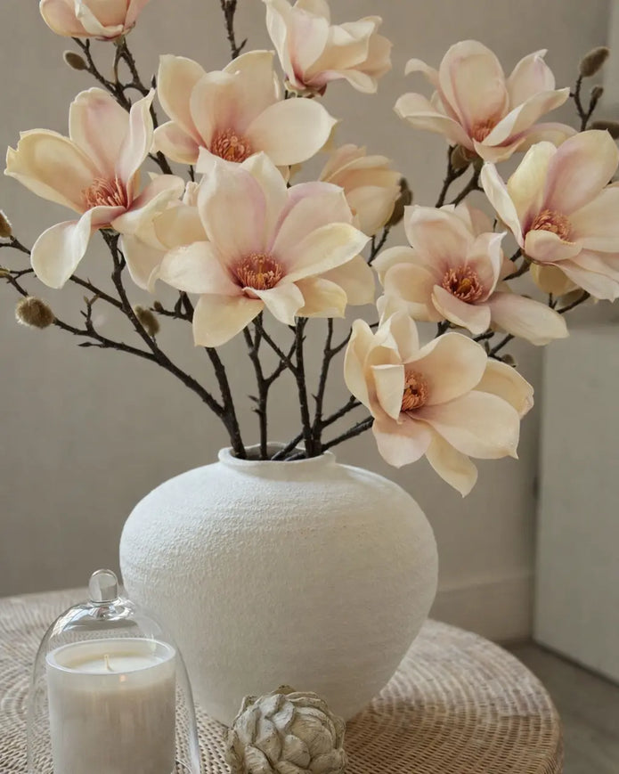 Artificial Pale Apricot Magnolia Branch Stem from Hill Interiors, showcasing realistic blossoms and green leaves on a natural-looking stem.