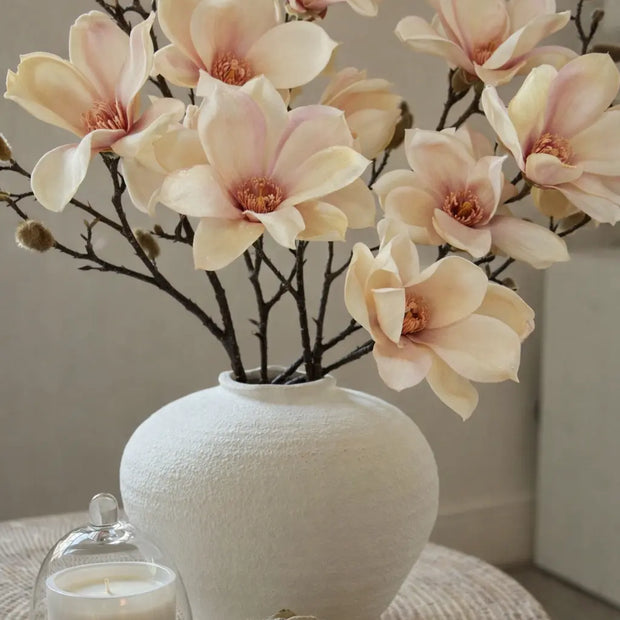 Artificial Pale Apricot Magnolia Branch Stem from Hill Interiors, showcasing realistic blossoms and green leaves on a natural-looking stem.