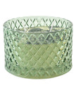 Embossed green glass candle with Corsia scent by Candlelight Products Ltd, showcasing a decorative scented candle.