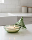 Olive green embossed tagine-shaped glass candle for home decor by Candlelight Products Ltd, displayed on a neutral background.