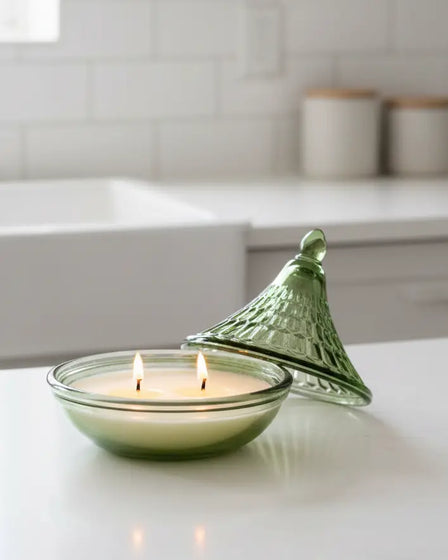 Olive green embossed tagine-shaped glass candle for home decor by Candlelight Products Ltd, displayed on a neutral background.