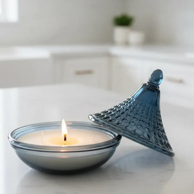 Navy blue embossed tagine glass candle for home decor by Candlelight Products Ltd, featuring intricate design and warm candlelight glow.