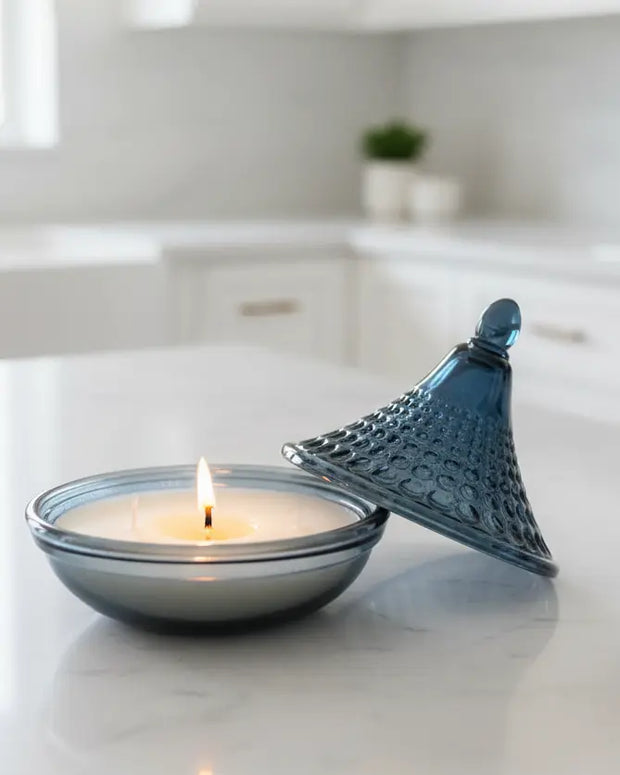 Navy blue embossed tagine glass candle for home decor by Candlelight Products Ltd, featuring intricate design and warm candlelight glow.