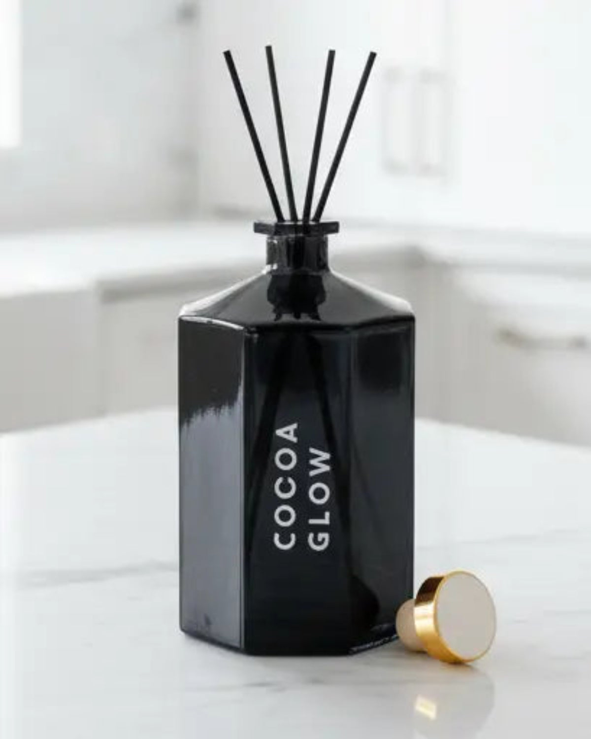 Black octagonal reed diffuser by Candlelight Products Ltd with reeds and decorative packaging visible, perfect for home scenting.