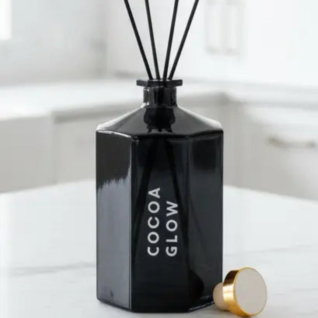 Black octagonal reed diffuser by Candlelight Products Ltd with reeds and decorative packaging visible, perfect for home scenting.