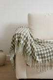 Olive green houndstooth blanket throw from Ellenvale Trade, soft furnishings with a cozy, stylish pattern, draped over a surface.