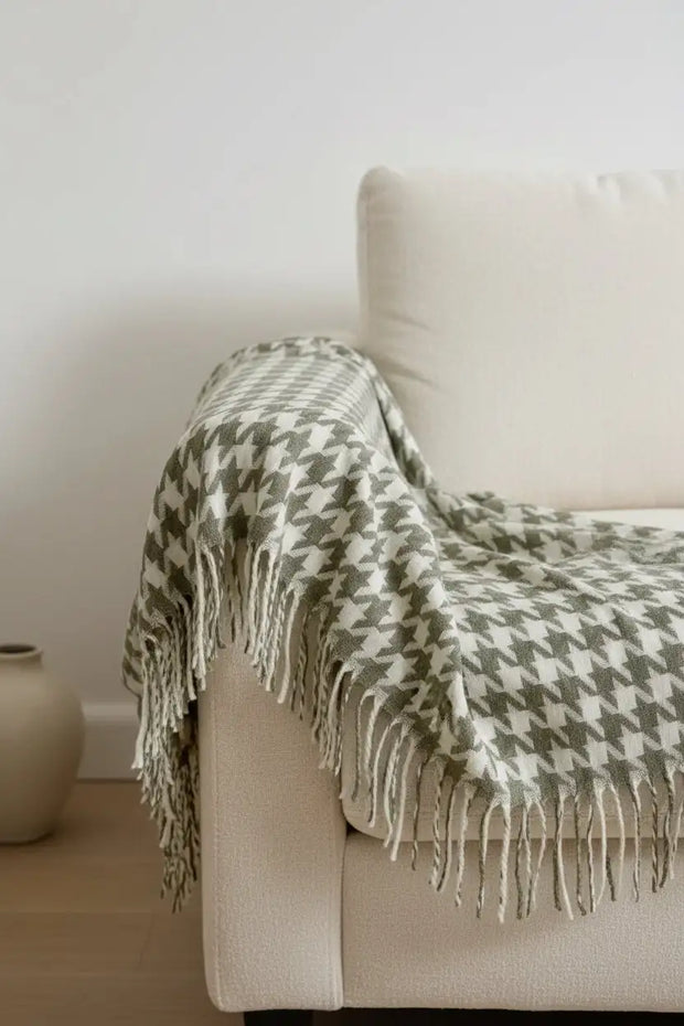Olive green houndstooth blanket throw from Ellenvale Trade, soft furnishings with a cozy, stylish pattern, draped over a surface.