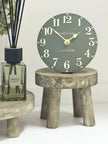 Gisela Graham wooden display milking stool used as rustic home decor with a natural wood finish.