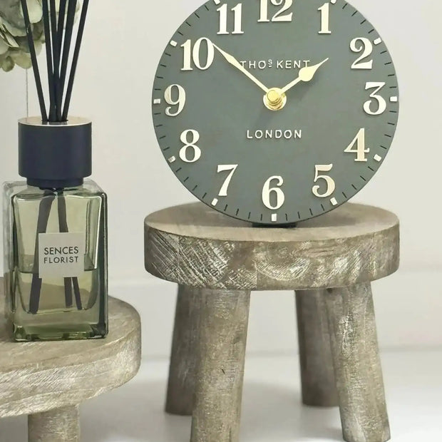 Gisela Graham wooden display milking stool used as rustic home decor with a natural wood finish.