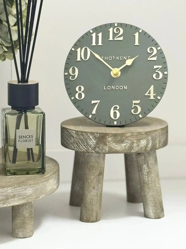 Gisela Graham wooden display milking stool used as rustic home decor with a natural wood finish.