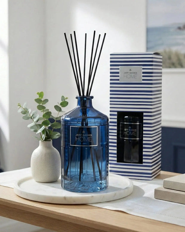 Blue striped Jeff Banks reed diffuser from Candlelight Products Ltd, 1000ml, with glass container and reed sticks for fragrance.