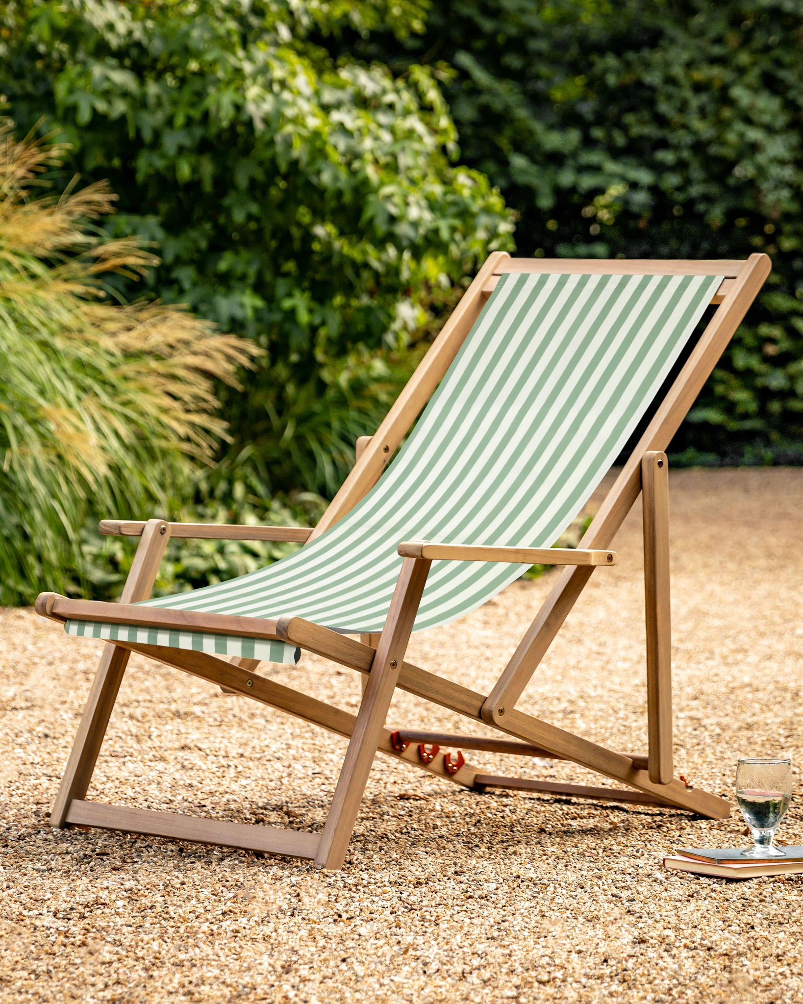 Creta wooden striped garden chair in sage green from Gallery Direct, showcasing a stylish outdoor furniture piece with a slatted design.