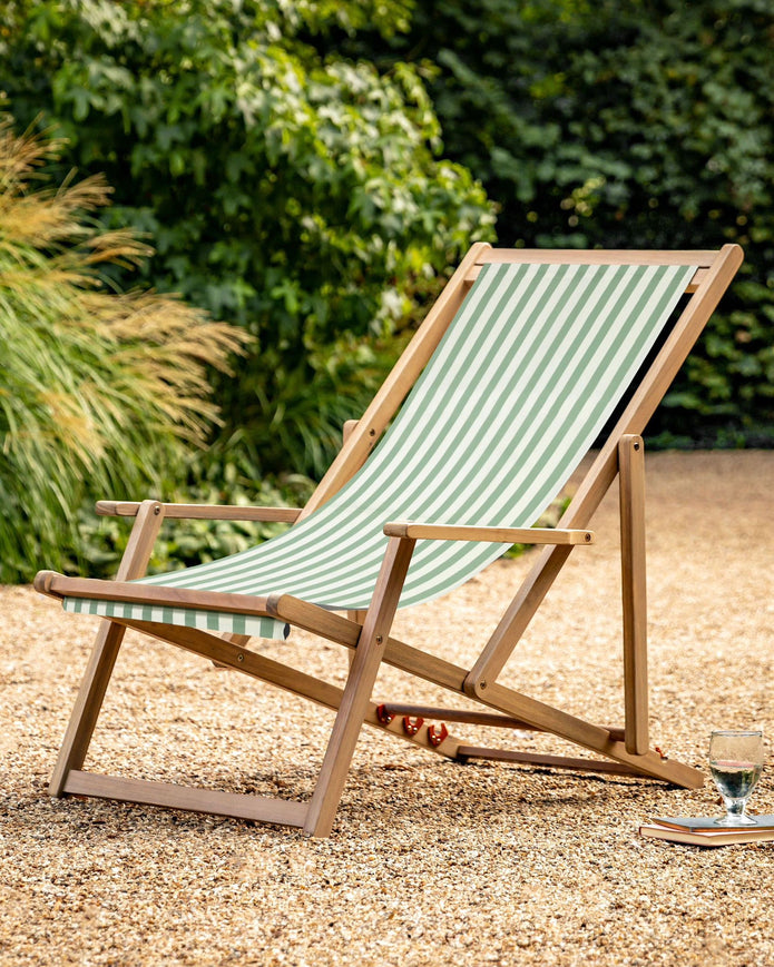 Creta wooden striped garden chair in sage green from Gallery Direct, showcasing a stylish outdoor furniture piece with a slatted design.