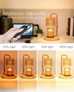 Adjustable candle lamp with brightness control on a desk setup.