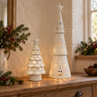 White metal LED cutout Christmas trees in Large and Extra Large sizes styled side by side