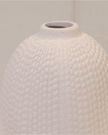 White textured vase on a light gray background