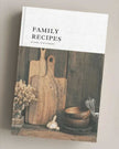 Book titled 'Family Recipes' with a wooden cutting board and kitchen items on the cover.