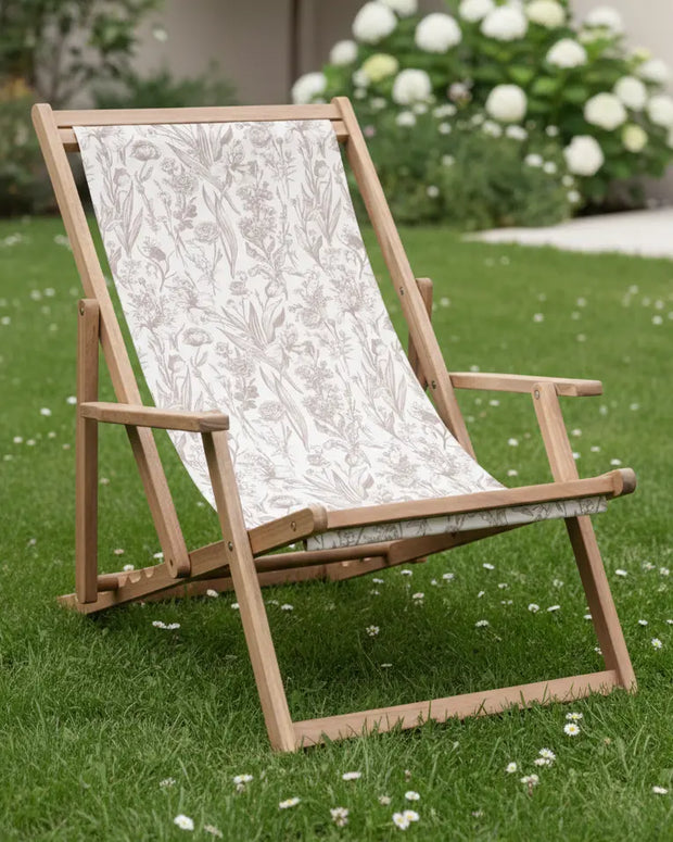 Creta wooden floral deck chair in beige, a garden furniture piece by Gallery Direct, with a floral-patterned wooden design for outdoor seating.