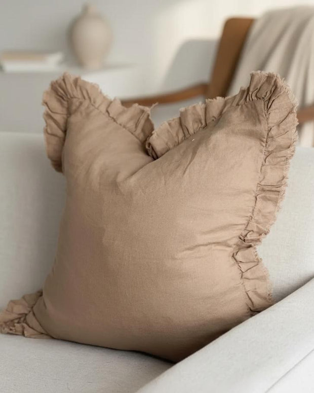 Rust brown square linen blend cushion cover with ruffle details, soft furnishings by Ellenvale Trade, shown in a cozy indoor setting.