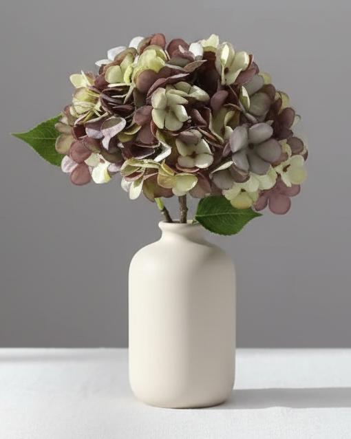 Artificial dusky plum hydrangea stem from Starlight Express, showcasing vibrant, lifelike hydrangea blossoms on a realistic plant stem.