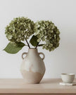 Artificial short sage green hydrangea stem from Starlight Express, showcasing lush green blooms and realistic floral details.