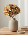 Artificial short dusky apricot hydrangea stem from Starlight Express, showcasing vibrant apricot blossoms on a realistic plant stem.