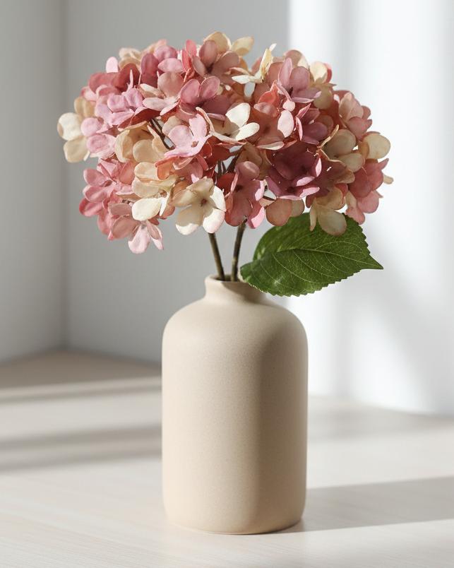 Artificial short pink hydrangea stem from Starlight Express, featuring vibrant pink blooms and green foliage for decorative use.