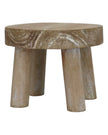Gisela Graham wooden display milking stool used as rustic home decor with a natural wood finish.