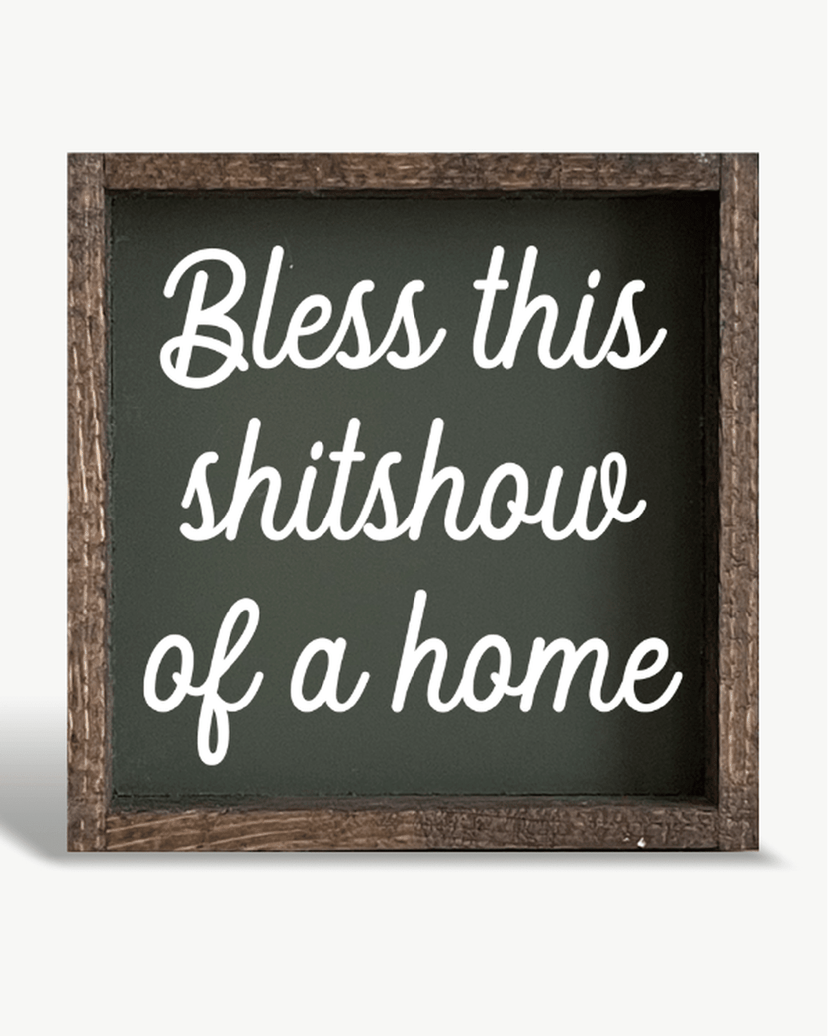 Decorative sign with text 'Bless this shitshow of a home' on a white background