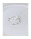 Silver ring with a pearl on a white dish