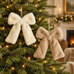Cream and warm beige fluffy bow hangers displayed together on a Christmas tree