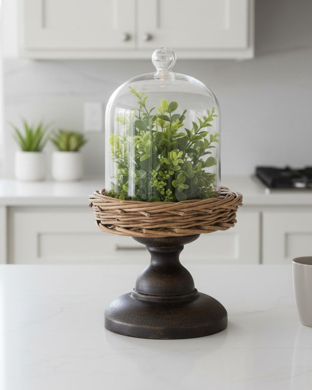 Small glass cloche with metal and wicker base, decorative home décor piece by Heaven Sends.
