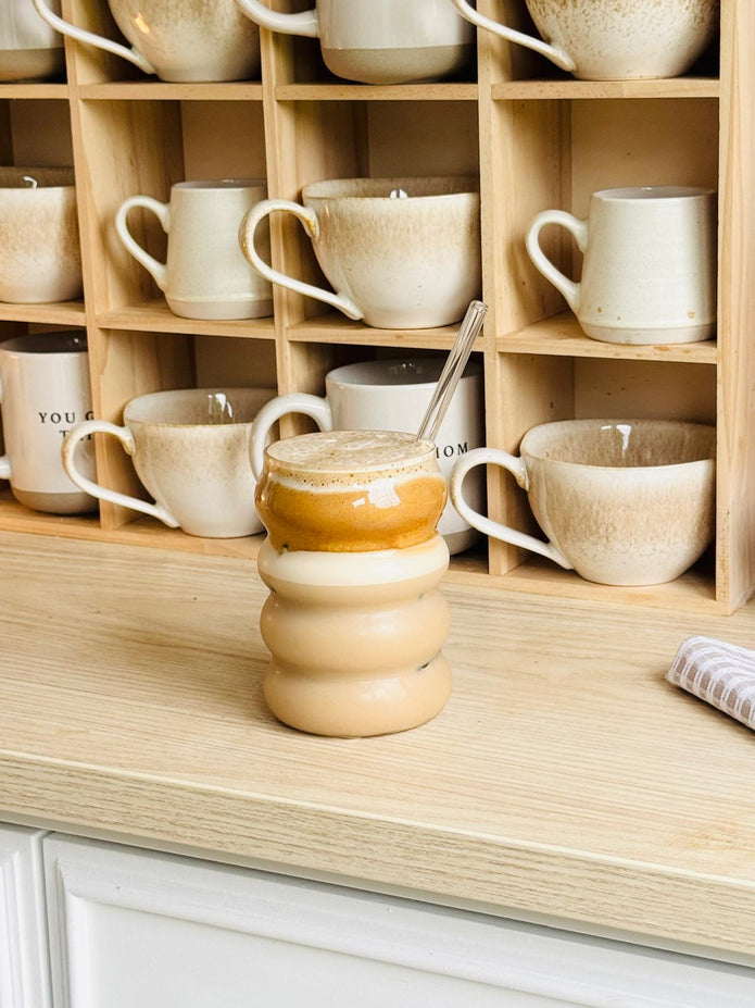 Starlight Express bubble glass coffee mug with clear straw, ideal for iced coffee, in a kitchen and dining setting.