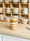 Starlight Express bubble glass coffee mug with clear straw, ideal for iced coffee, in a kitchen and dining setting.
