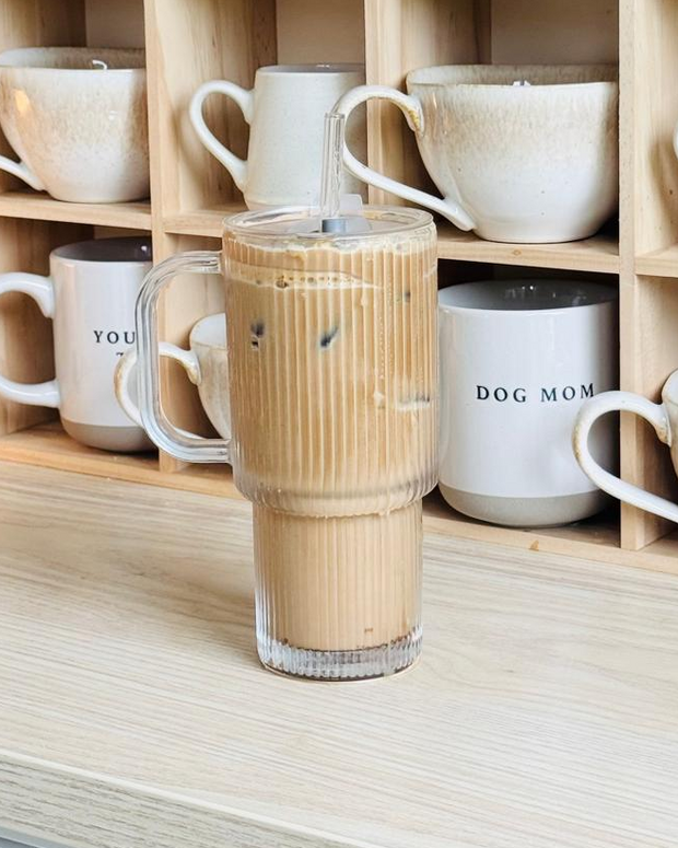 Glass ribbed ‘Stanley’ style iced coffee travel cup by Starlight Express, featuring a clear design with a lid and handle for on-the-go use.