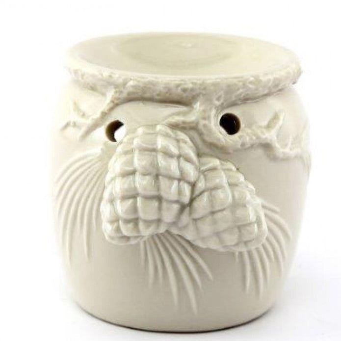 White Christmas Wax Oil Burner With Pinecones, cream wax burner with raised pinecones against white
