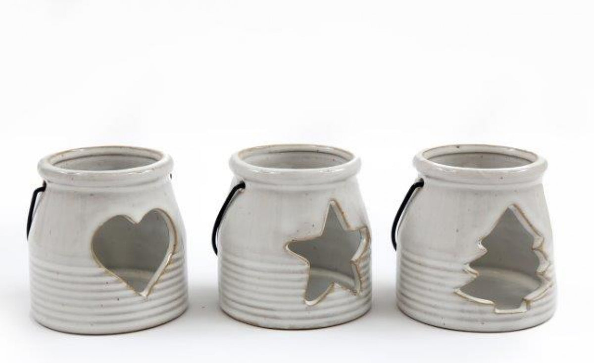 White Ceramic Tealight Holder With Handle, three cream lanterns with heart, star and tree cutouts