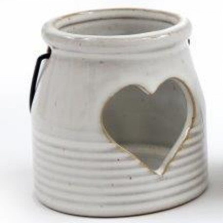 White Ceramic Tealight Holder With Handle, close-up of the cream heart-cutout lantern and dark handle