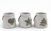 White Ceramic Tealight Holder With Handle, three cream lanterns with heart, star and tree cutouts