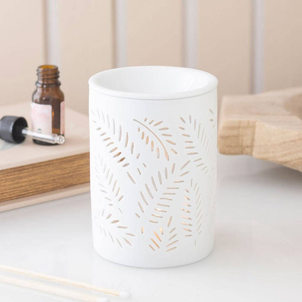 White leafy fern design wax melt burner and oil warmer for aromatherapy, featuring cut-out leaf patterns and a sleek white finish.