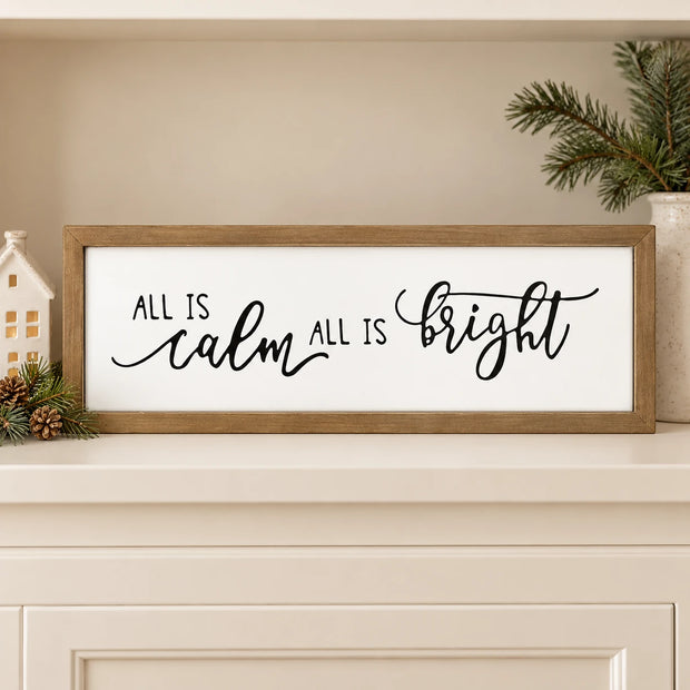 All Is Calm All Is Bright wooden sign on a cream shelf