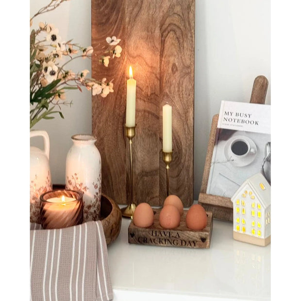 Antique Brass Effect Taper Candlestick, two brass-effect candlesticks with cream tapers in a kitchen display