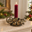 Antique bronze Originals International floral and leaf chamber stick candle holder on a mantelpiece