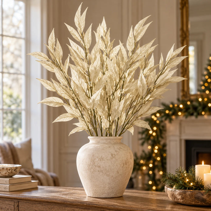 Full arrangement of multiple 85cm artificial cream leaf stems in a stone-coloured vase; vase excluded.