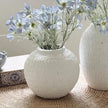 Ashen White Matt Round Vase, round white vase with blue flowers beside a taller vase