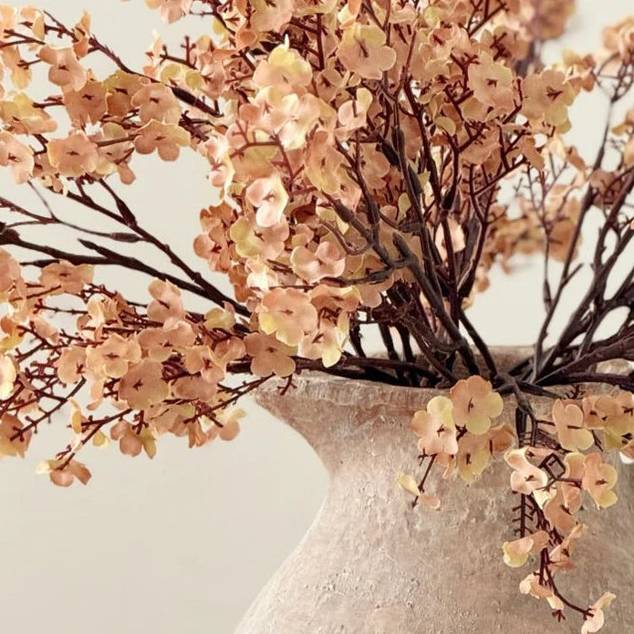 Artificial Peach And Brown Gypsophelia Stem, close-up of peach and brown flowers above the jug rim
