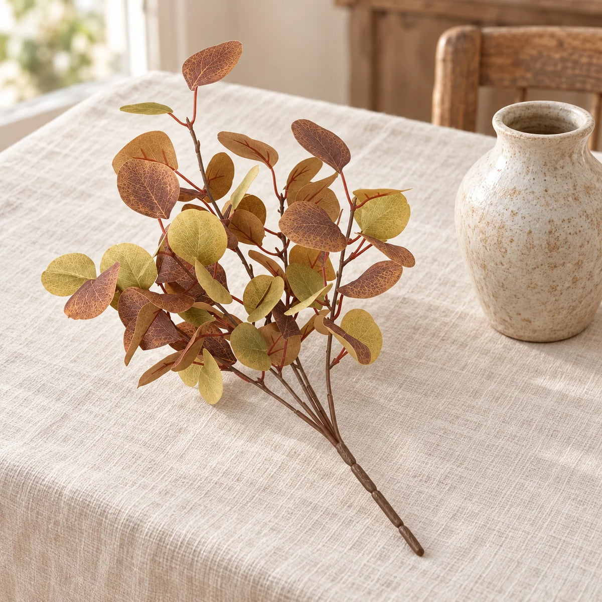 Christmas eucalyptus leaf sprig by Heaven Sends with green eucalyptus leaves and small white accents, styled for autumn decor.