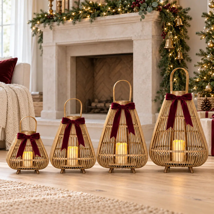 Four graduated bamboo LED lanterns with burgundy bows beside a Christmas fireplace; each sold individually