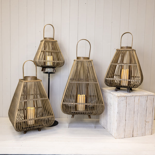 Four bamboo LED lanterns in different sizes arranged on pale display stands; each sold individually