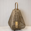 Angled view of a bamboo lantern showing its tapered slats, rounded base, arched handle and LED candle